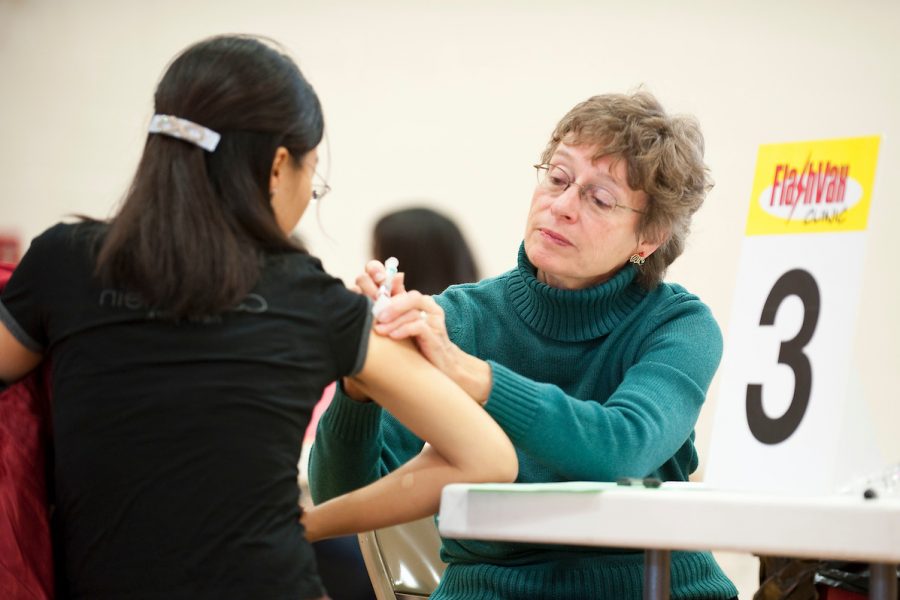 A student receives a flu shot at a campus clinic