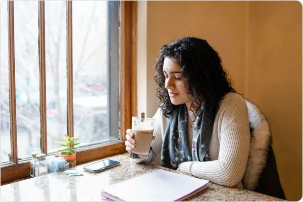 women drinking something milky at a cafe