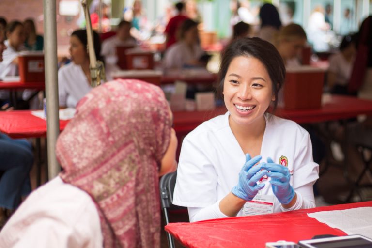 Nurse smiling at patient before giving flu shot