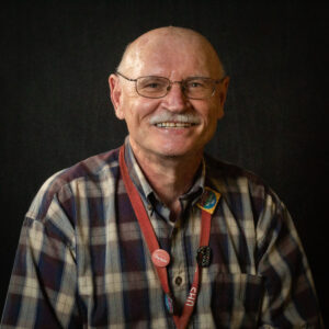 Felix Savino wearing a plaid shirt and UHS lanyard