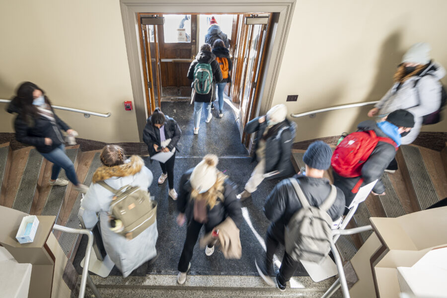 Students pictured in the entry way of a campus building going to call