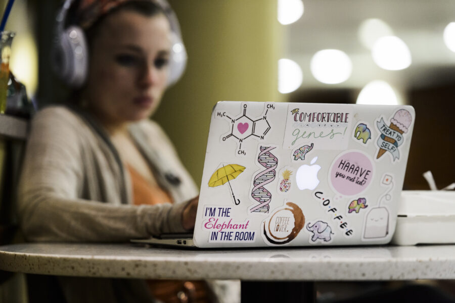 Undergraduate Reagan Stultz uses her sticker-covered laptop to review notes for an upcoming chemistry exam as she studies at Union South