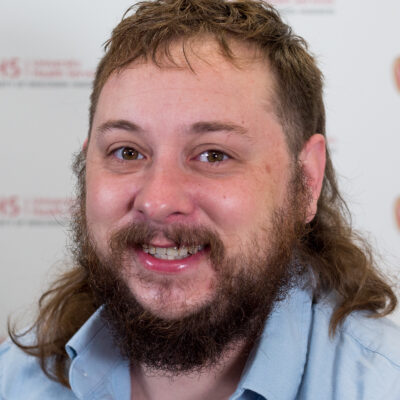 Louis Lindley is a man with shoulder-length brown hair and a beard.