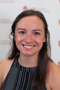 Rhiannon Lee Kunesh is a woman with long brown hair.