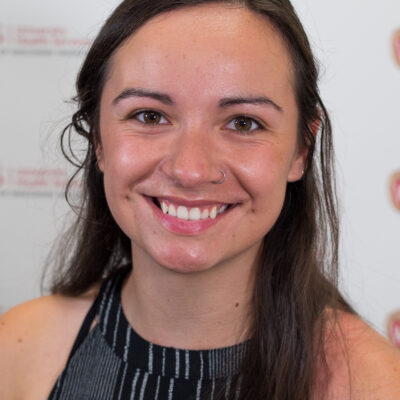 Rhiannon Lee Kunesh is a woman with long brown hair.