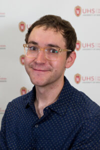 Shane Sommers is a man with short brown hair and glasses.