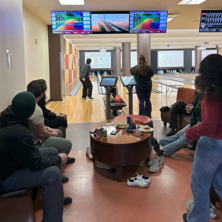 A group of people playing bowling