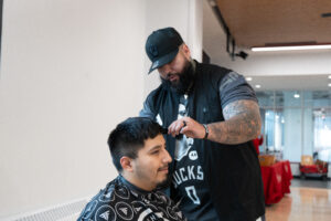 Male cutting another male's hair