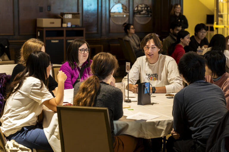 Students chatting and dining around a circular table