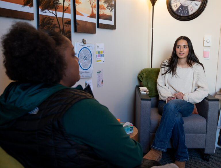 Survivor Services, mental health provider, Kayla Eggen sitting across from a student conversing.