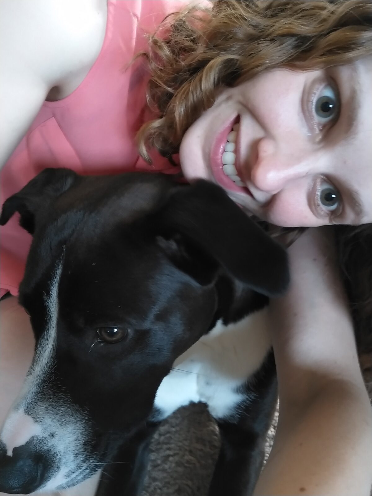 Casey smiling with her dog.