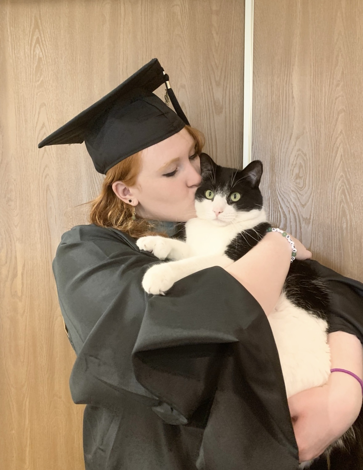 Kari Treu kissing her cat.