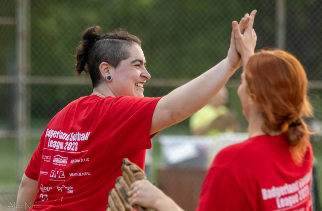 Mariessa Robles high-fiving softball teammate.