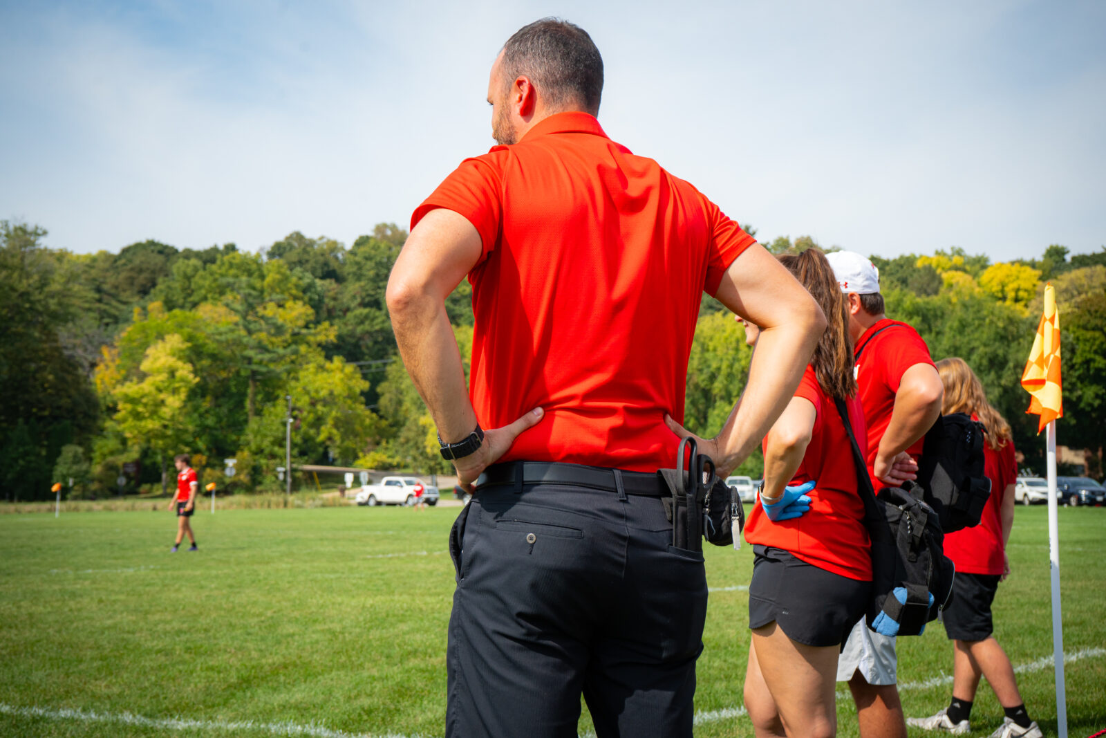 Kyle Gibson stands by the sidelines of a rugby match