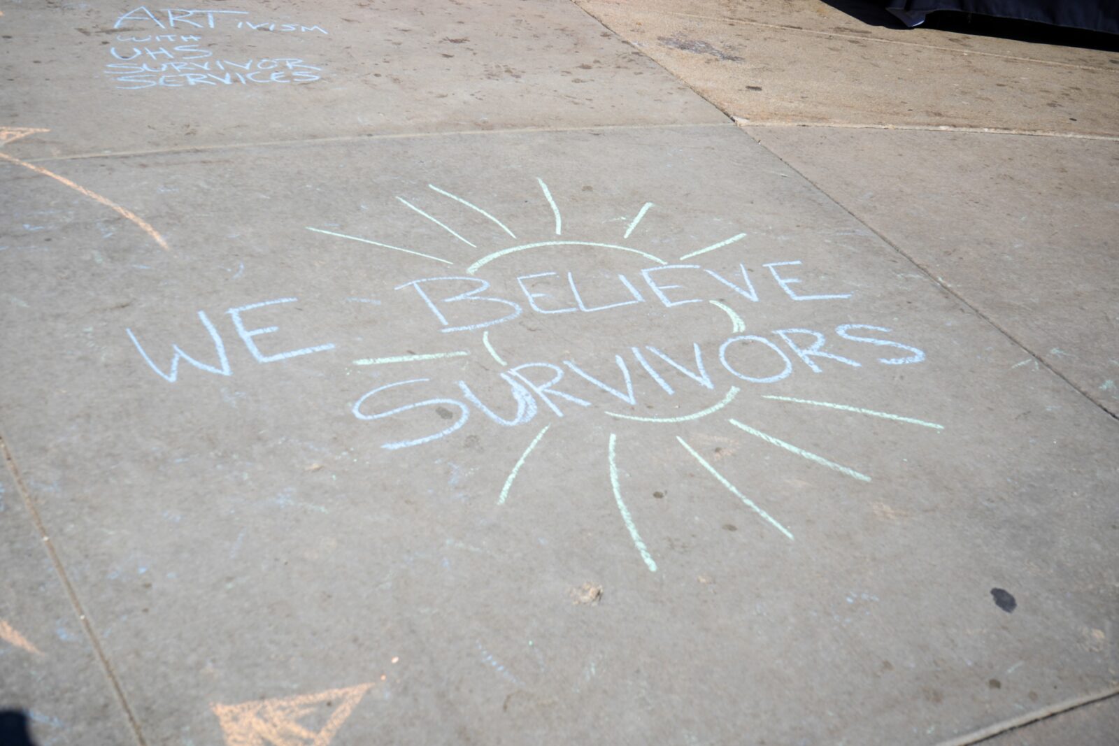 We believe survivors written on the sidewalk in chalk