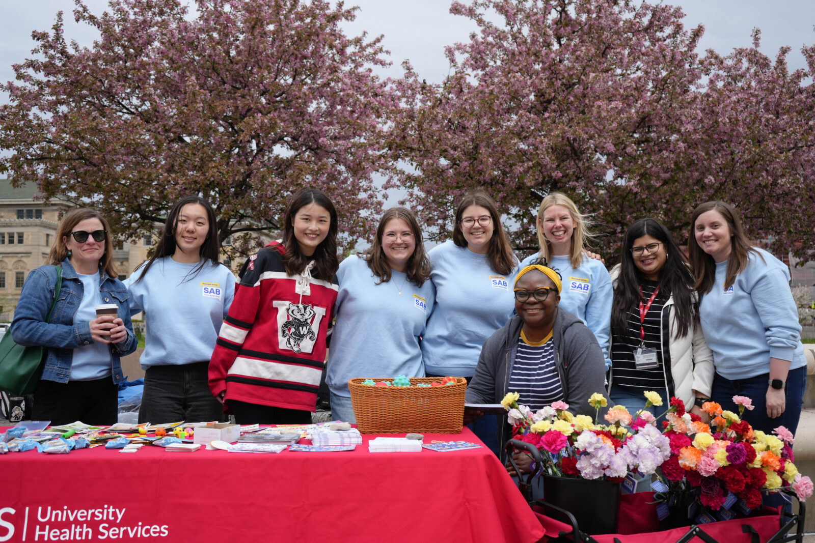 Student Advisory Board members smile with mental health providers at their annual Flower of Gratitude event.