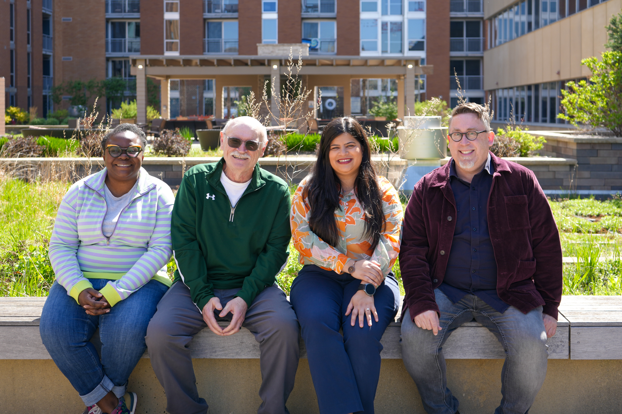 Mental health providers seated outside talking and smiling with each other
