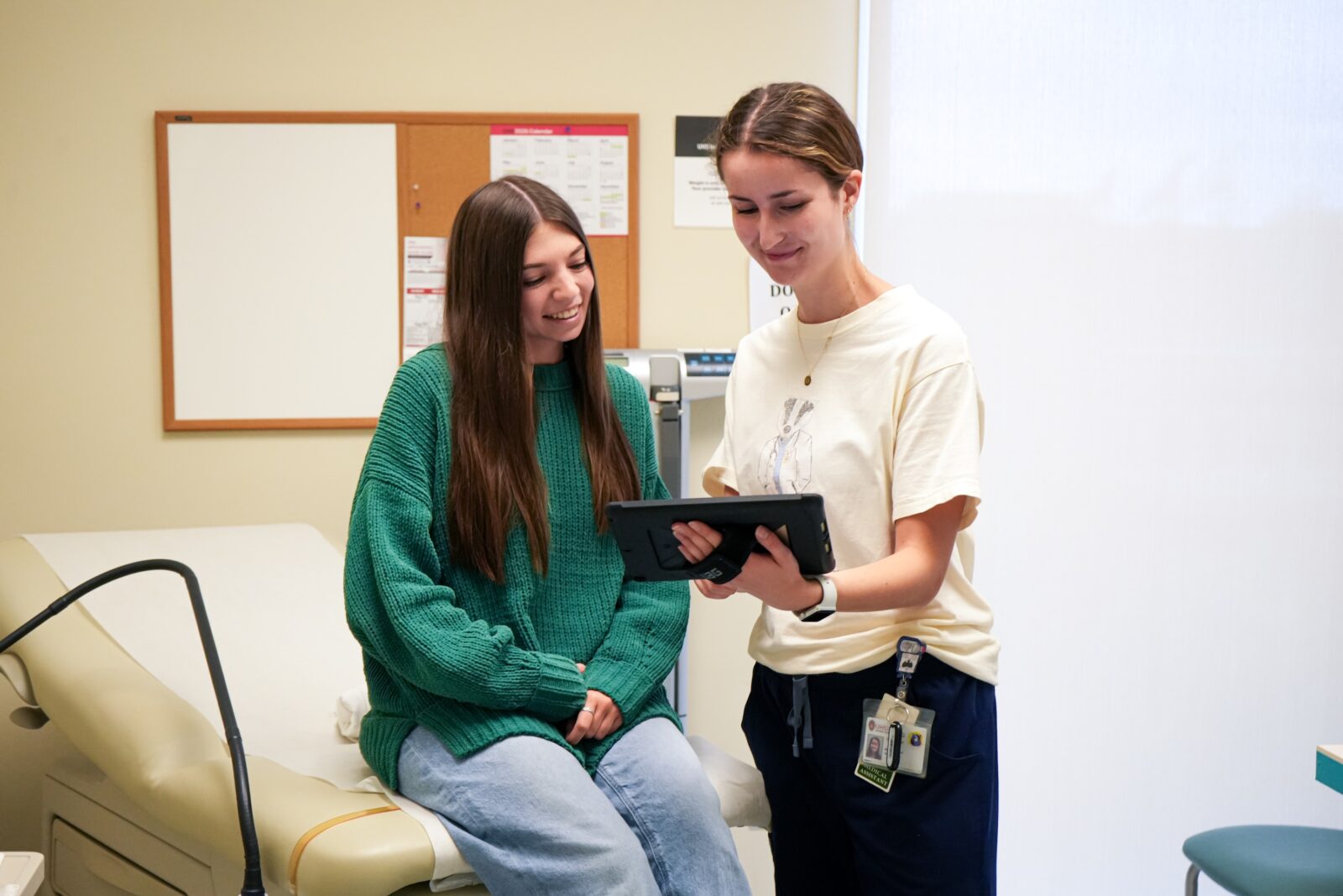 Patient and Medical Assistant in a medical exam room